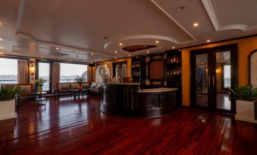 Elegant cruise lounge interior with panoramic windows and wooden flooring, perfect for relaxing duri.
