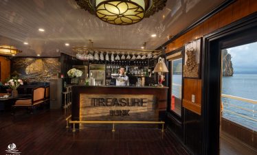 Elegant cruise bar scene on Bai Tu Long Bay with ocean view and luxurious ambiance.