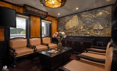 Luxury cruise lounge with traditional decor and scenic views in Bai Tu Long Bay.