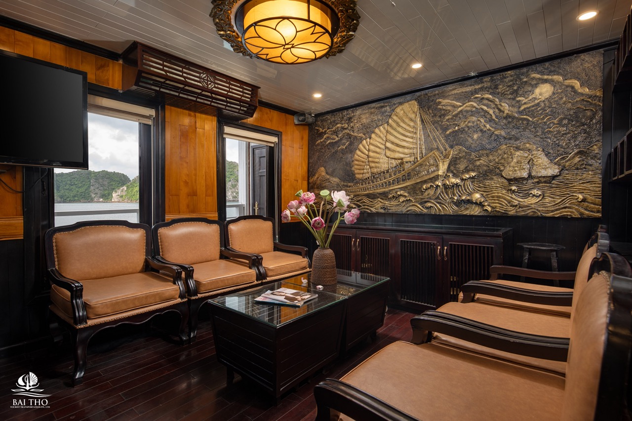 Luxury cruise lounge with traditional decor and scenic views in Bai Tu Long Bay.