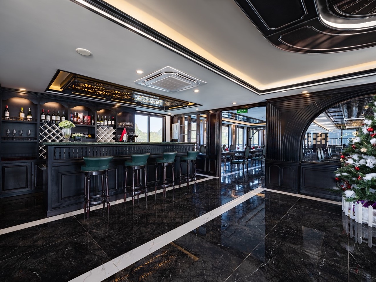 Luxurious cruise lounge with panoramic windows and elegant decor in Halong Bay.