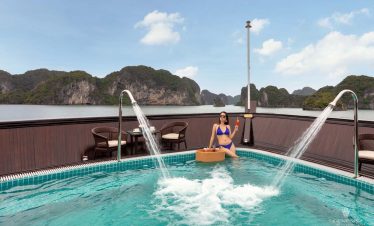 Enjoy stunning Halong Bay scenery from the cruise balcony with relaxing atmosphere.