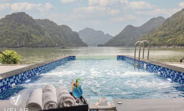 Stunning view of Halong Bay from the cruise balcony with relaxing poolside scene.
