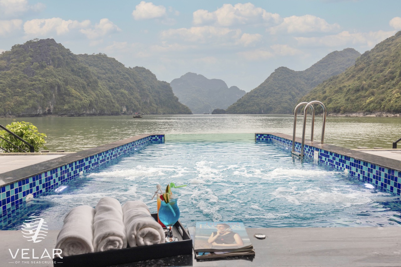 Stunning view of Halong Bay from the cruise balcony with relaxing poolside scene.