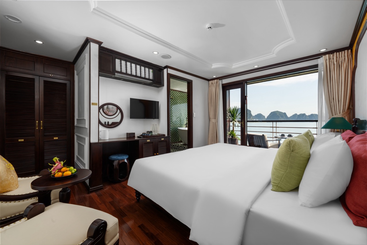 Beautiful cruise balcony view of Bai Tu Long Bay showcasing tranquil waters and limestone karsts.