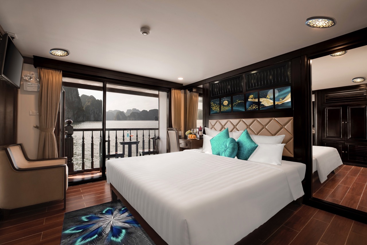 Stunning view of Halong Bay from a cruise balcony with elegant interior and serene atmosphere.