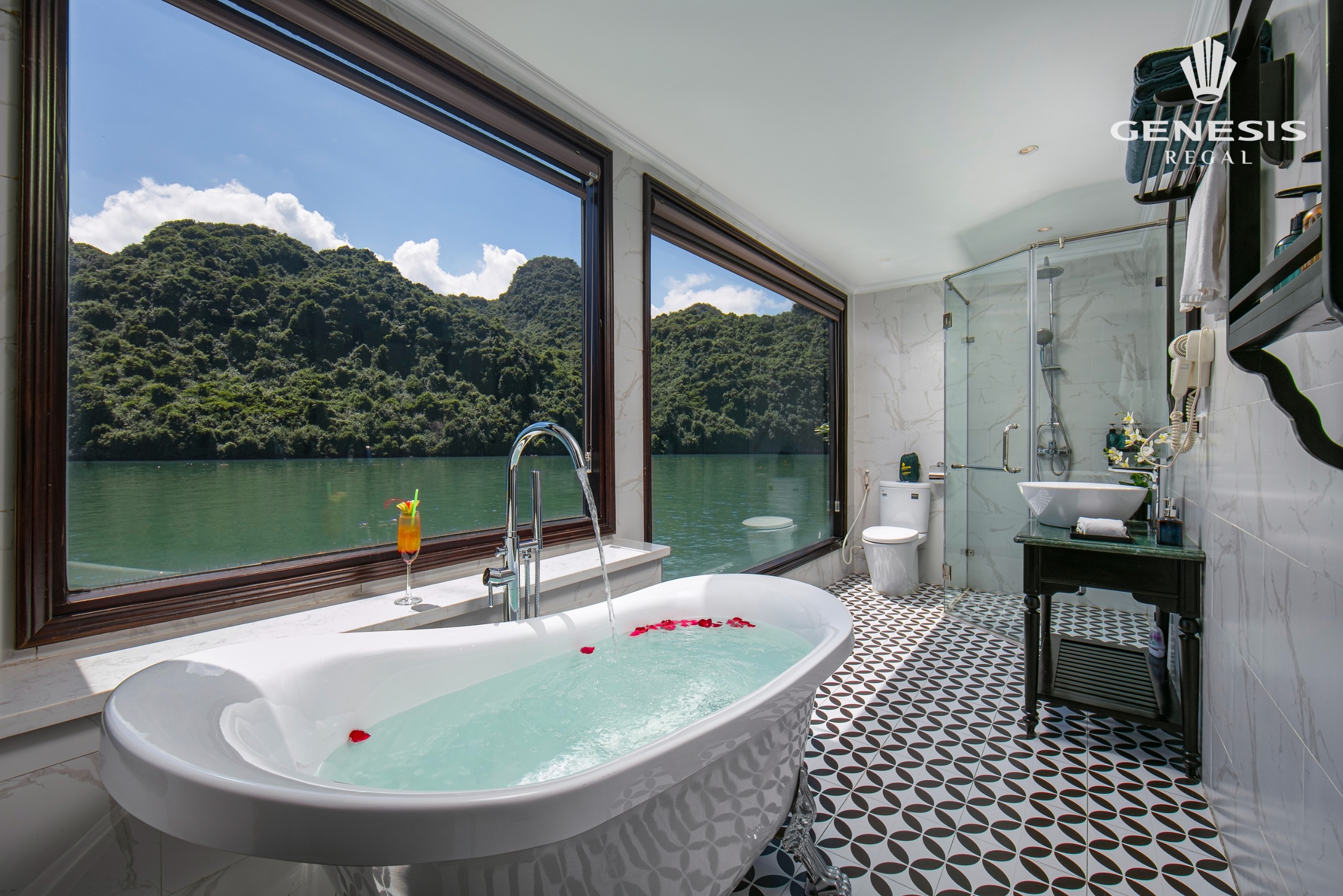 Beautiful bathroom with panoramic windows overlooking Halong Bay, perfect for relaxation.