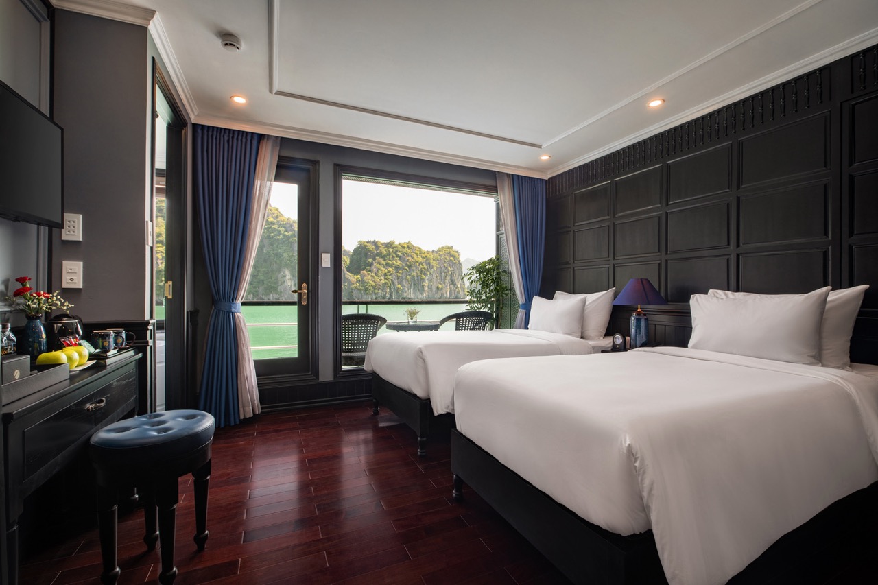 Stunning view of Halong Bay from a cruise balcony, perfect for a romantic getaway or relaxing vacati.