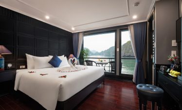 A romantic cruise balcony view of Halong Bay with lush islands and calm waters, perfect for a memora.