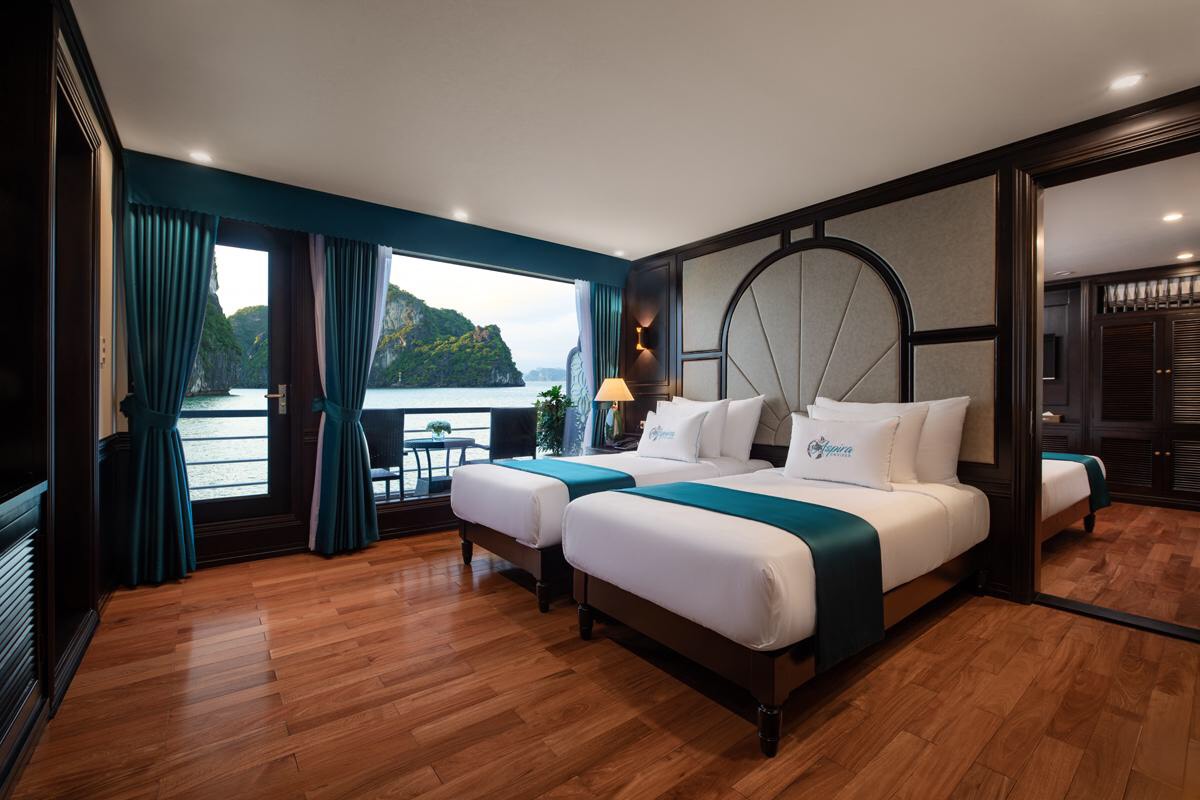 Sea view hotel room with elegant decor and balcony overlooking nature, perfect for relaxation.