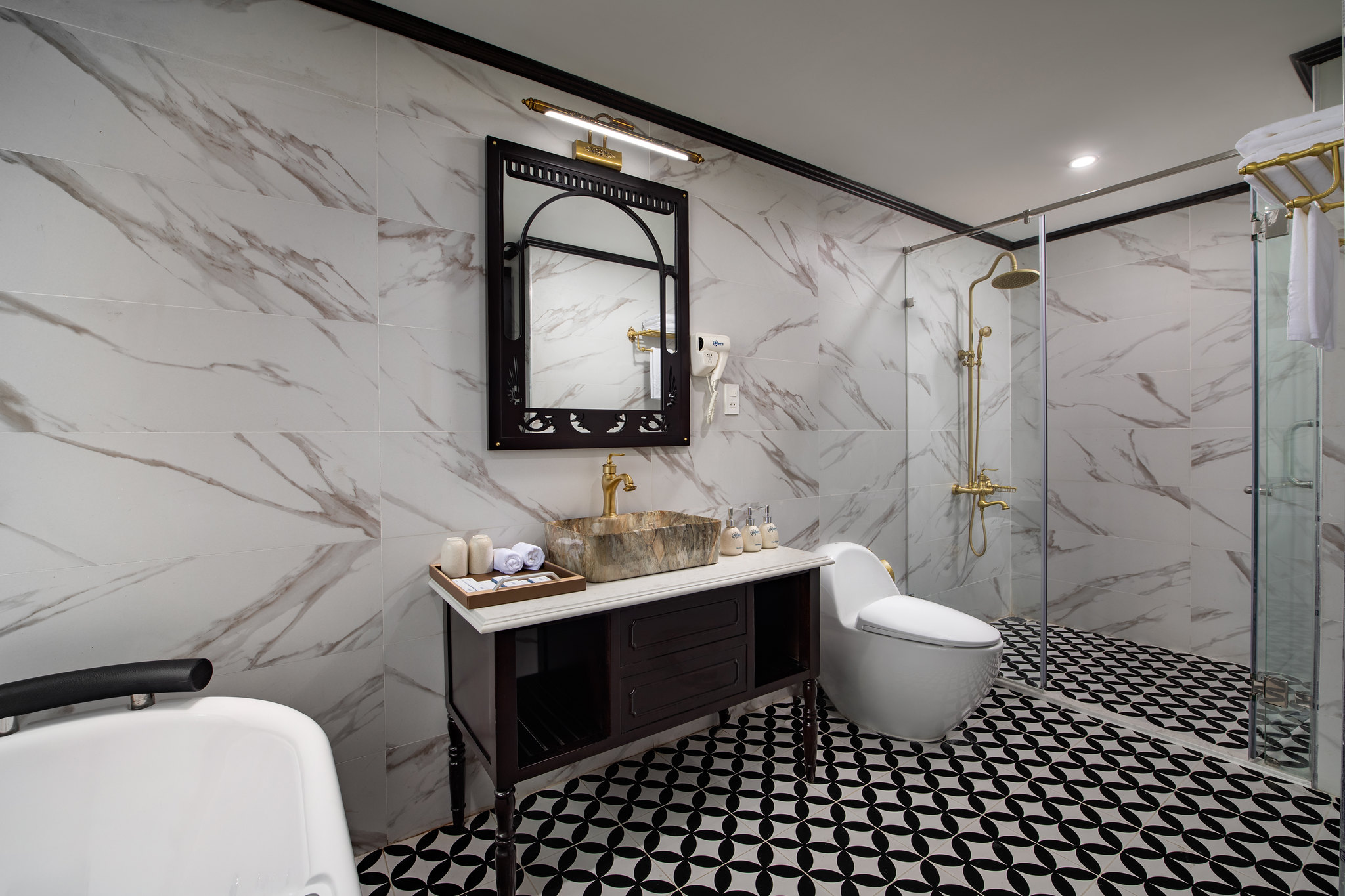 Luxurious modern bathroom with marble walls and black-and-white patterned floor.
