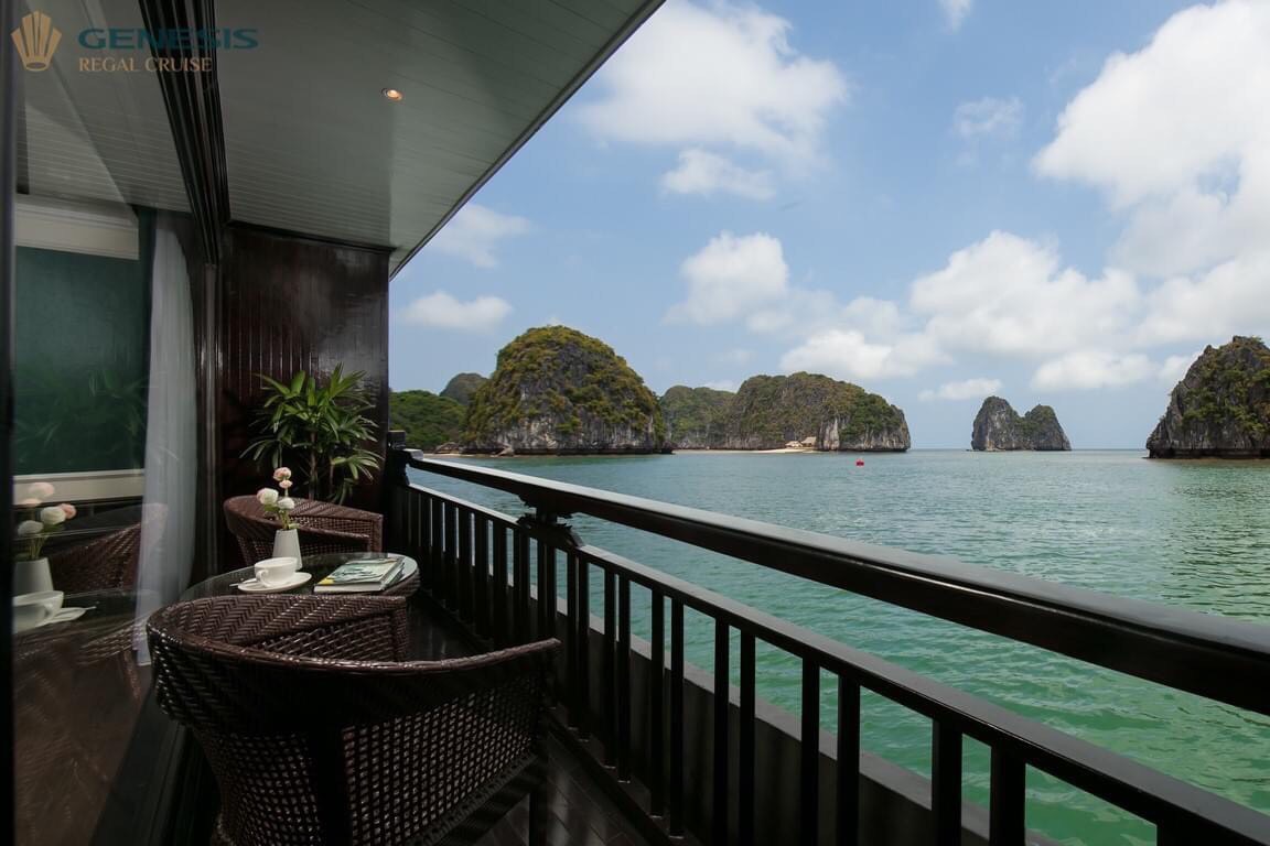 Stunning view from the cruise balcony overlooking Halong Bay's emerald waters and limestone islands.