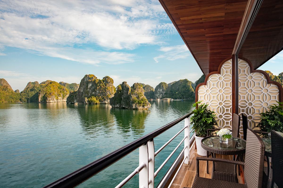 Breathtaking view of limestone islands from a luxury boat deck in Ha Long Bay, Vietnam.