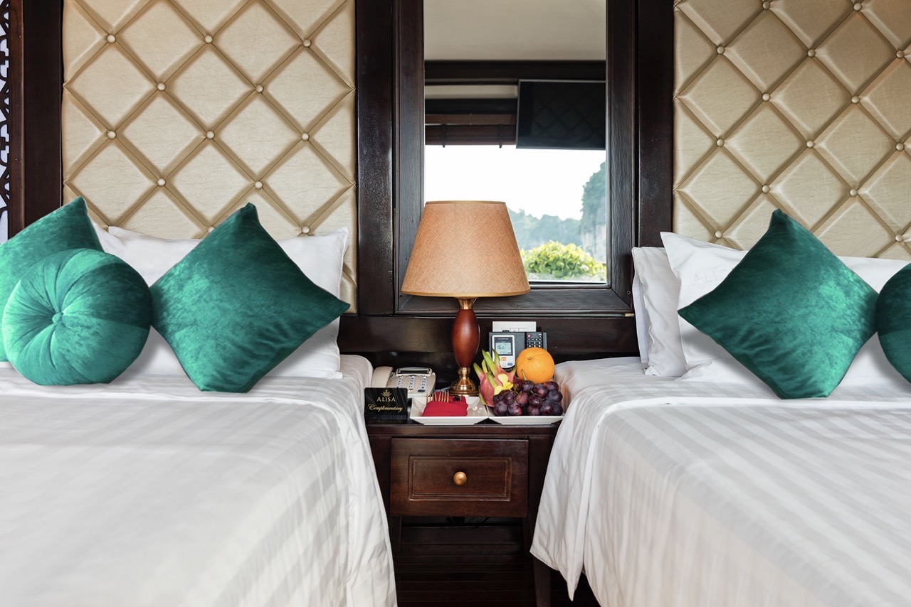 Beautiful hotel interior with twin beds, plush pillows, and a cozy ambiance.