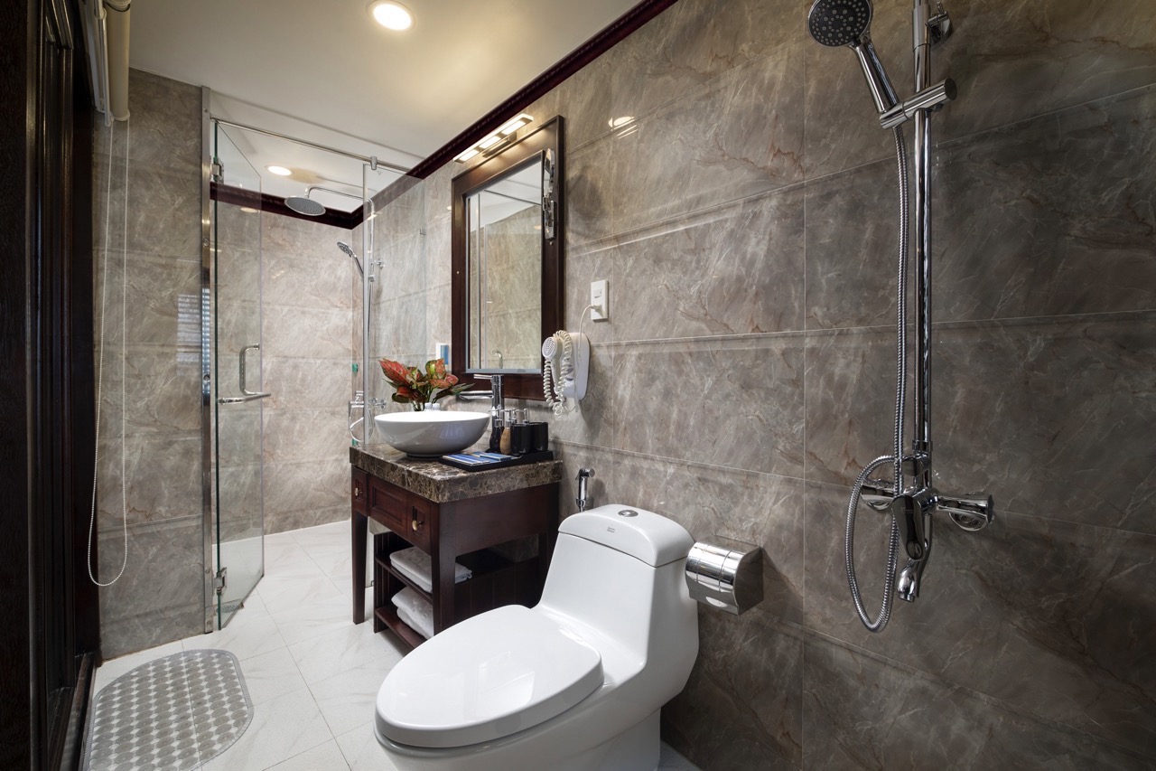 Spacious bathroom with modern amenities on Halong Bay cruise, offering comfort and luxury during you.