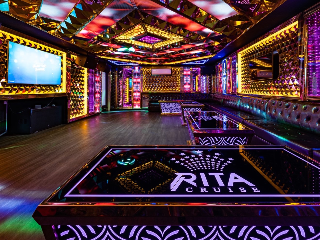 Luxurious cruise lounge with vibrant neon lights and modern decor on Halong Bay.