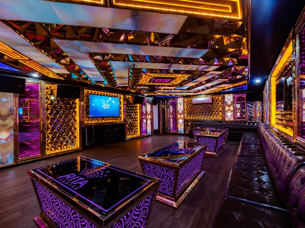 Luxurious cruise lounge with vibrant lighting and elegant decor in Halong Bay.