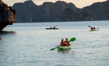Kayaking in Bai Tu Long Bay with scenic limestone islands and tranquil waters, perfect for adventure.