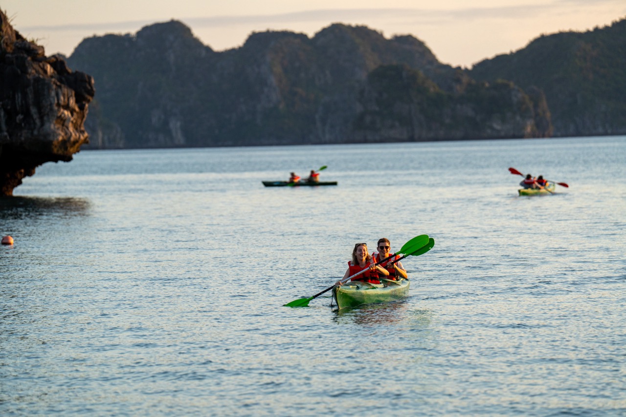 Kayaking in Bai Tu Long Bay with scenic limestone islands and tranquil waters, perfect for adventure.