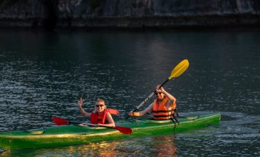 Kayaking in Bai Tu Long Bay with scenic limestone cliffs and calm waters, perfect for adventure and.