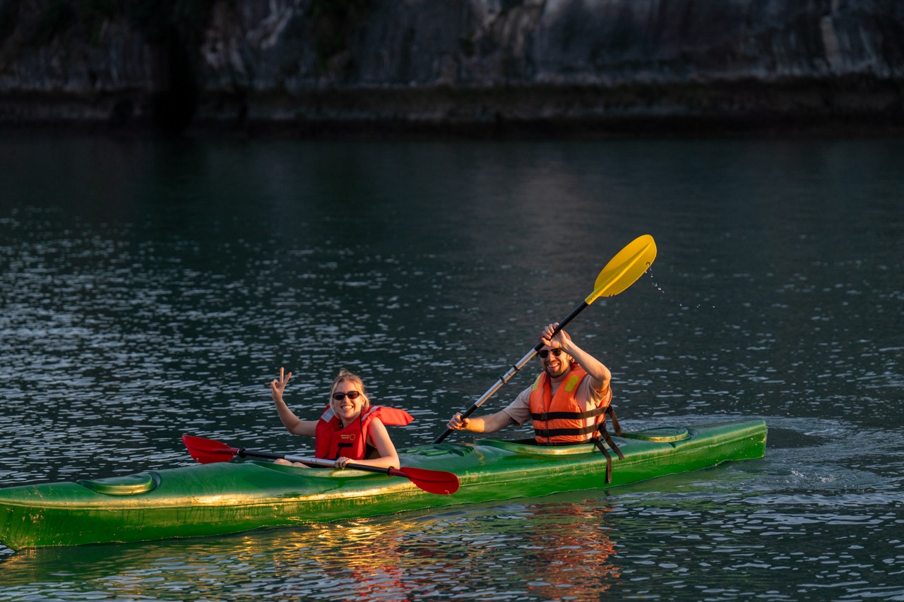 Kayaking in Bai Tu Long Bay with scenic limestone cliffs and calm waters, perfect for adventure and.