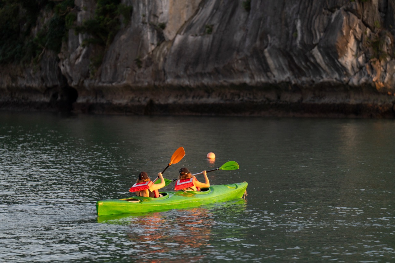 Kayaking adventure in Bai Tu Long Bay on a scenic cruise balcony.