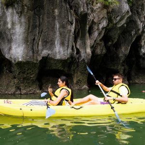 Serene kayak adventure along limestone karsts in Vietnam's scenic landscape.