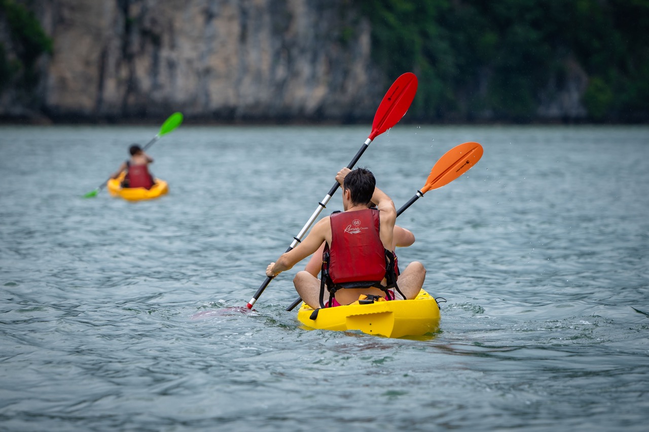 Kayaking in Halong Bay with vibrant scenery and tranquil waters, perfect for adventure and explorati.