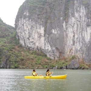 1. People kayaking in Halong Bay with stunning limestone karsts and emerald waters.
