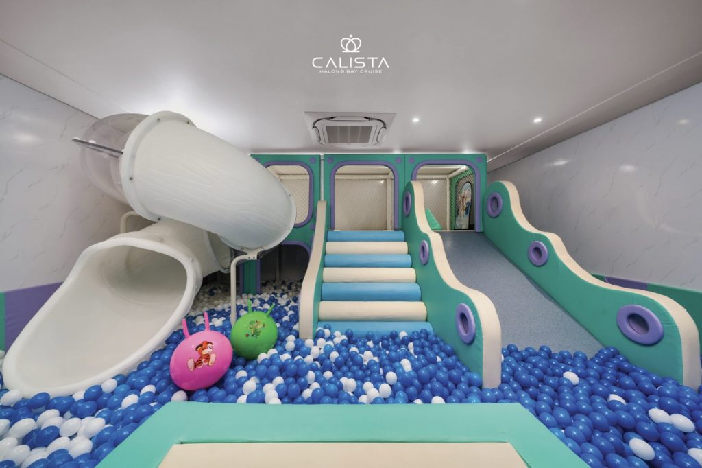 Indoor playground with slide and ball pit on Halong Bay cruise.