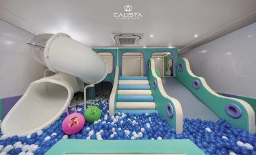 Indoor playground with slide and ball pit on Halong Bay cruise.
