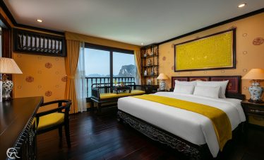 Stunning view from a cruise balcony in Halong Bay, showcasing tranquil waters and limestone karsts,.