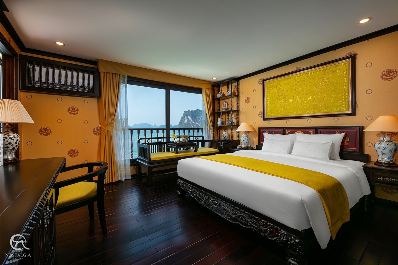 Stunning view from a cruise balcony in Halong Bay, showcasing tranquil waters and limestone karsts,.