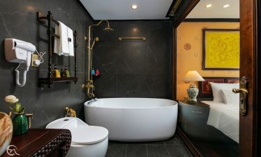 Scenic view of a luxurious bathroom with a bathtub overlooking Halong Bay, perfect for a relaxing cr.