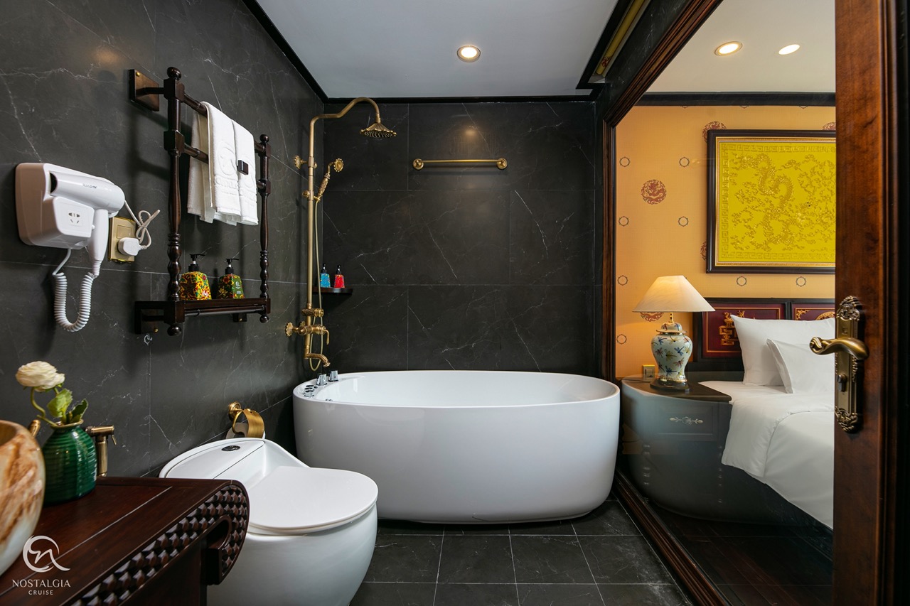 Scenic view of a luxurious bathroom with a bathtub overlooking Halong Bay, perfect for a relaxing cr.