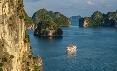 Stunning Halong Bay scenery with limestone karsts and calm waters, perfect for a relaxing cruise exp.