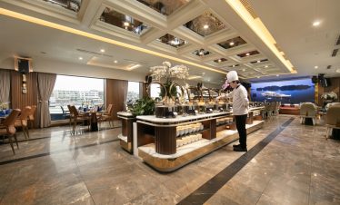 Luxurious cruise lounge with elegant decor and panoramic views of Halong Bay, perfect for relaxing d.