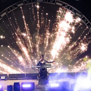 ViettrendTour fireworks celebration at night with vibrant stage lighting and performer.