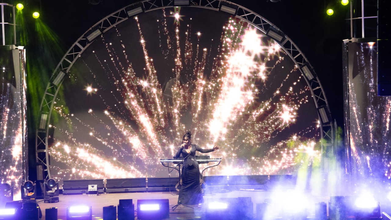 ViettrendTour fireworks celebration at night with vibrant stage lighting and performer.