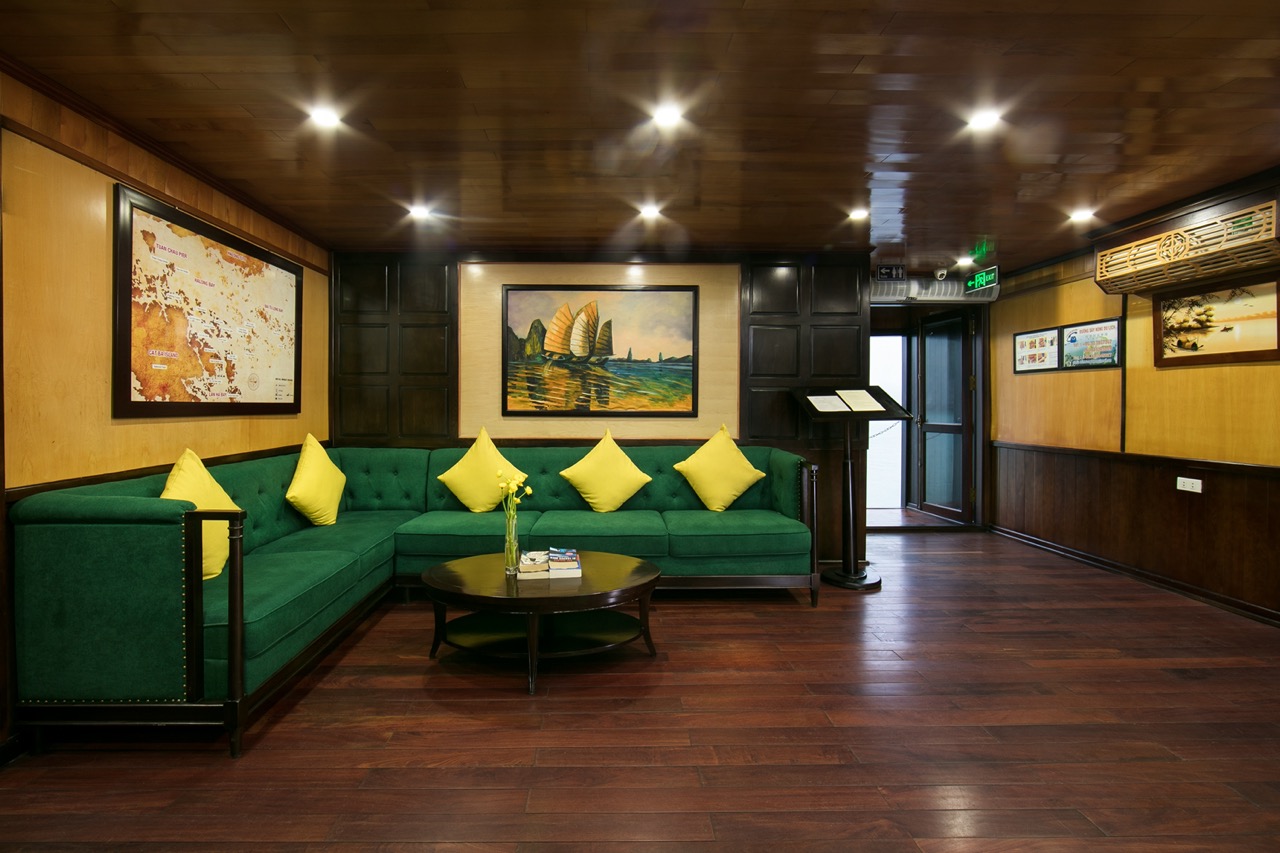 Relaxing cruise lounge with elegant decor and artwork, perfect for enjoying Halong Bay views.