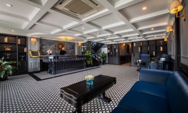 Elegant cruise lounge with luxurious decor and comfortable seating in Halong Bay.