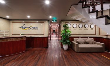 Relaxing cruise lounge with elegant decor and clock displays, perfect for travelers on Halong Bay cr.