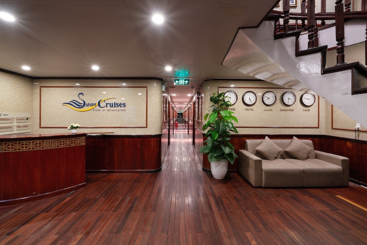 Relaxing cruise lounge with elegant decor and clock displays, perfect for travelers on Halong Bay cr.