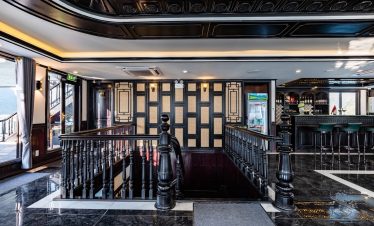 Elegant cruise lounge with stylish design and scenic views of Halong Bay, perfect for a relaxing 2D1.