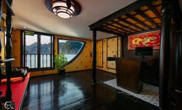 Luxurious cruise cabin with panoramic views of Halong Bay, perfect for a relaxing 2D1N cruise experi.