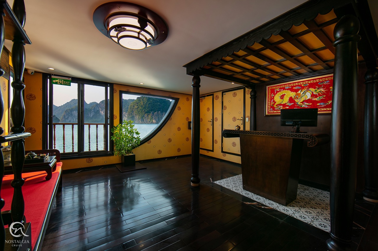 Luxurious cruise cabin with panoramic views of Halong Bay, perfect for a relaxing 2D1N cruise experi.