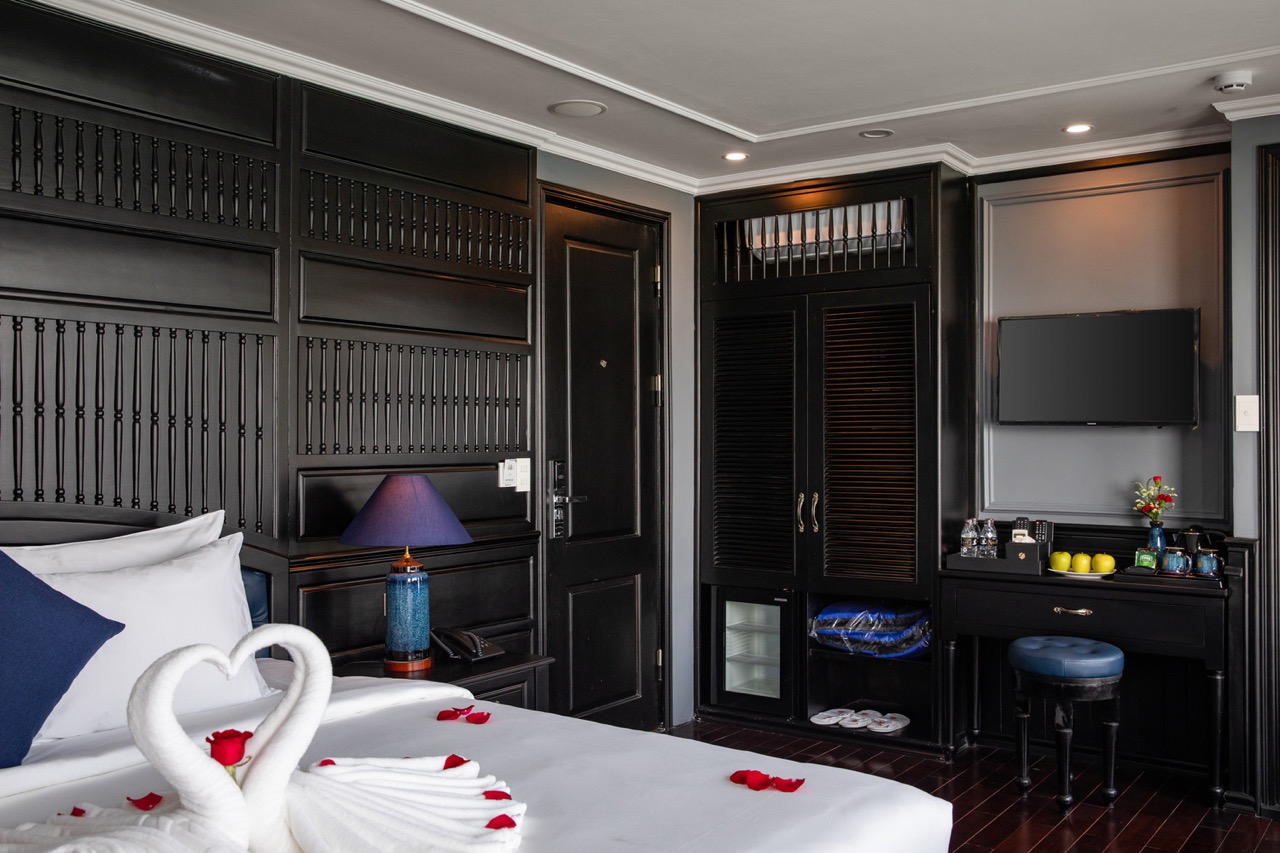 Stunning Halong Bay cruise balcony with luxurious interior and romantic swan towel arrangement.
