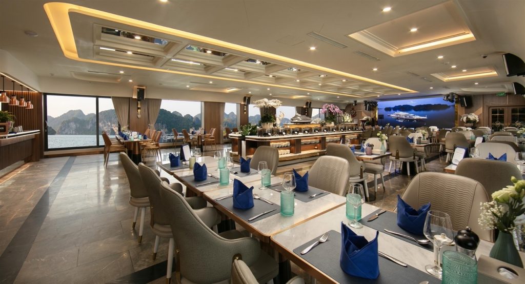 Elegant dining area with panoramic views of Halong Bay, perfect for a relaxing cruise experience.
