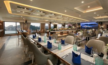 Elegant dining area with panoramic views of Halong Bay, perfect for a relaxing cruise experience.