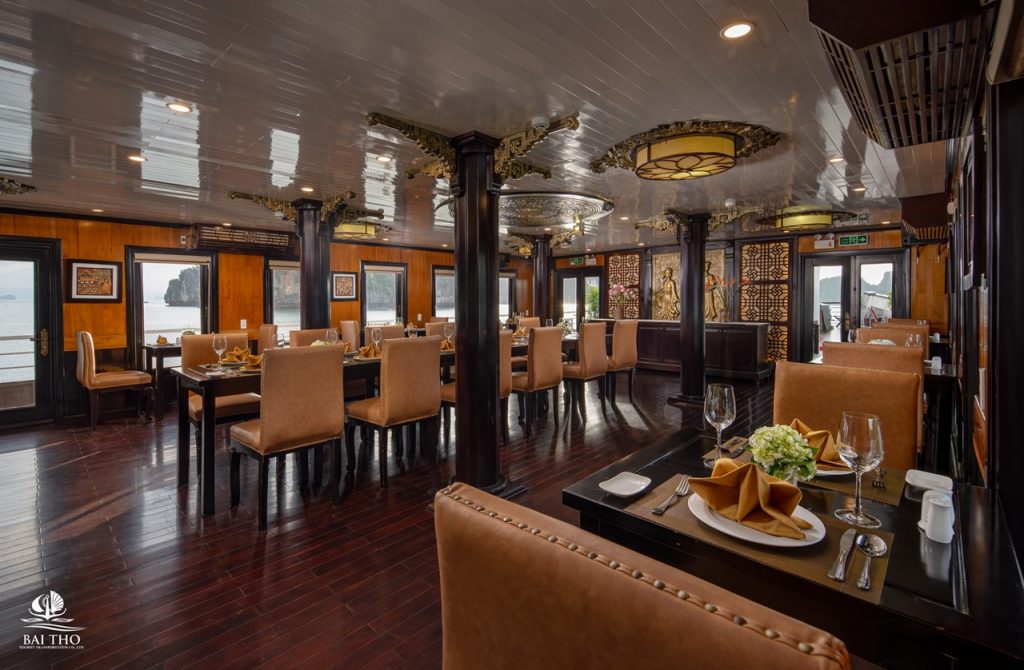 Elegant cruise dining room with panoramic views of Bai Tu Long Bay, perfect for a relaxing Vietnames.